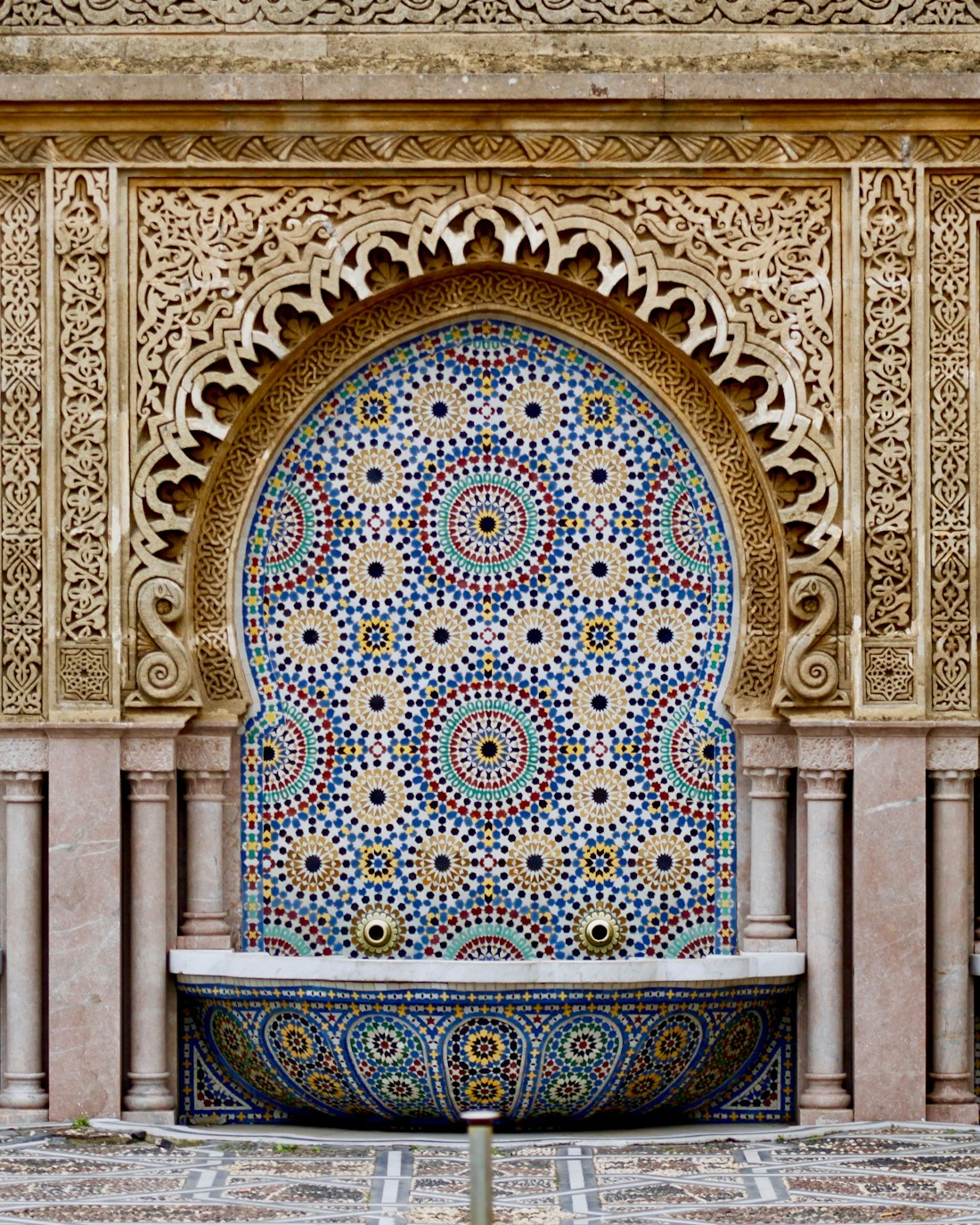 Hand-cut zellige tilework framing a Moorish arch
