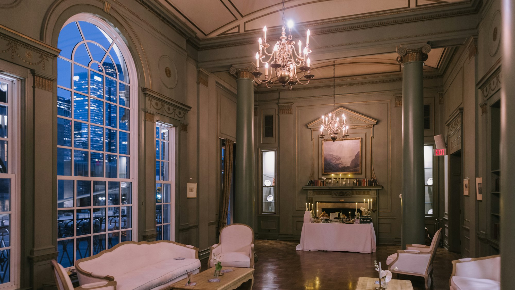 Chandeliered salon overlooking the city at night