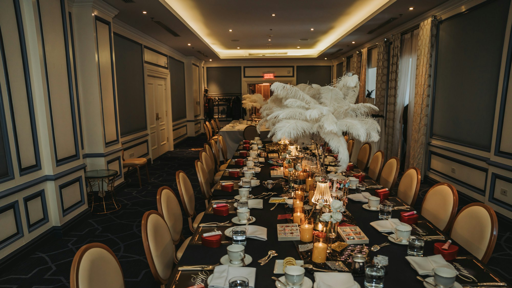 Long banquet table laid by candlelight